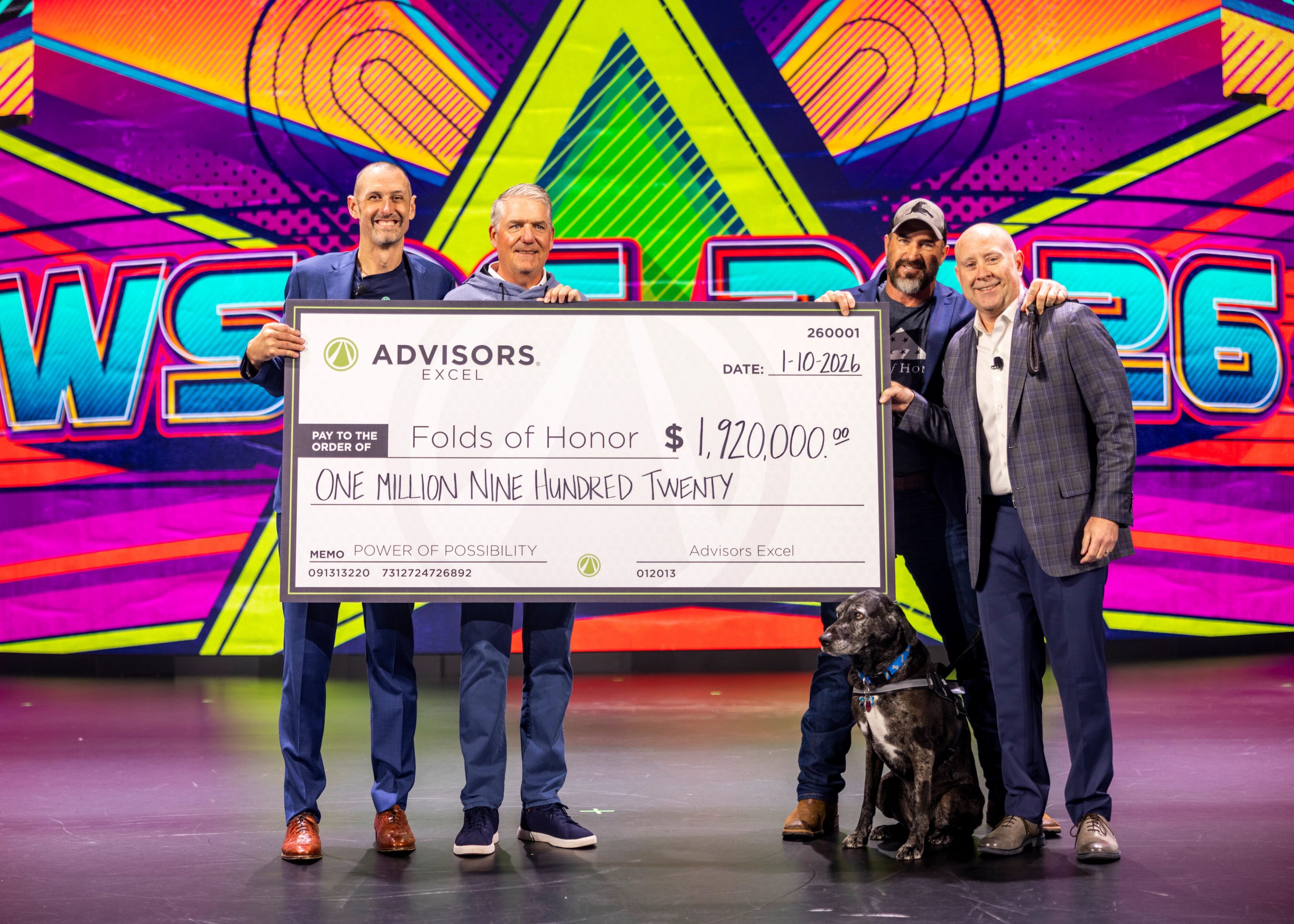 Advisors Excel Co-Founders David Callanan and Cody Foster present a donation check to Folds of representatives, Mike 'Boots' Barker and Larry Robinson.